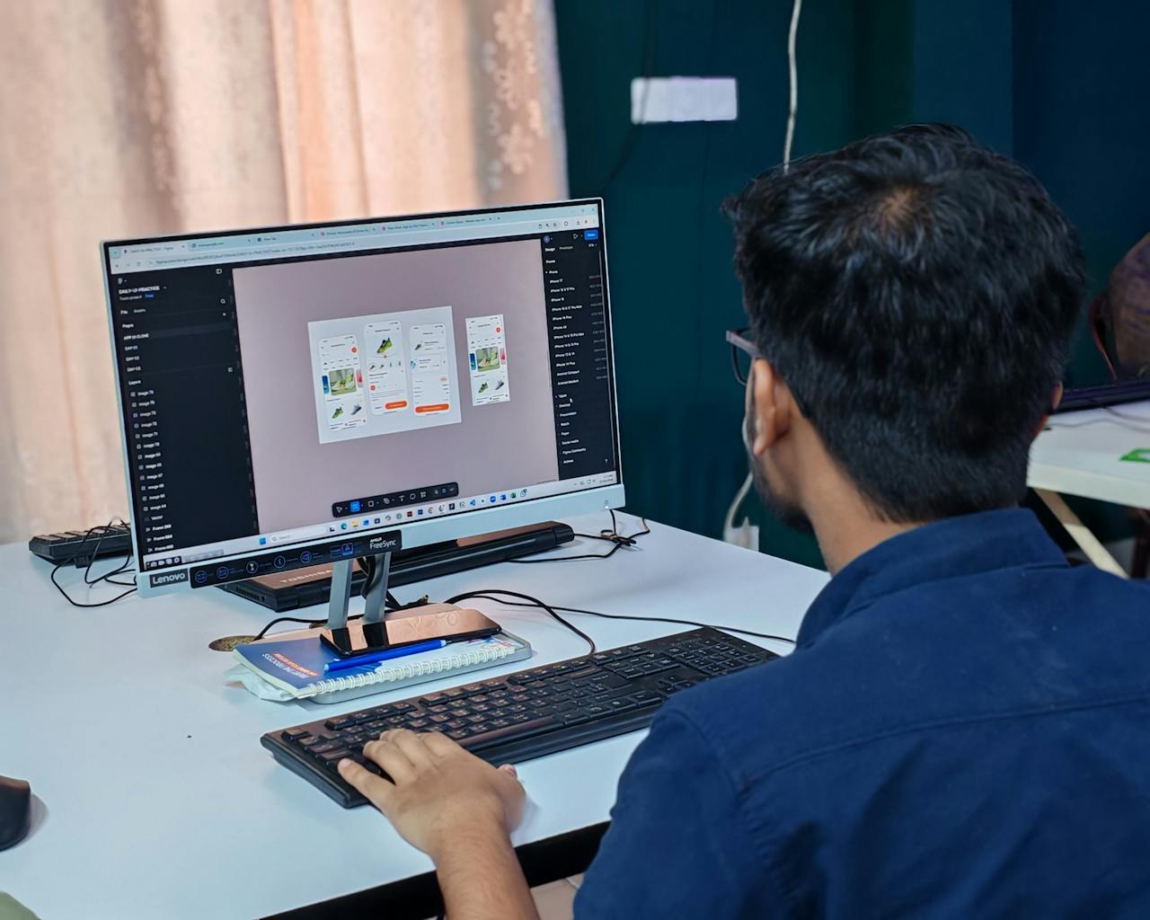 young-designer-at-work-creating-ui-on-desktop-36747234